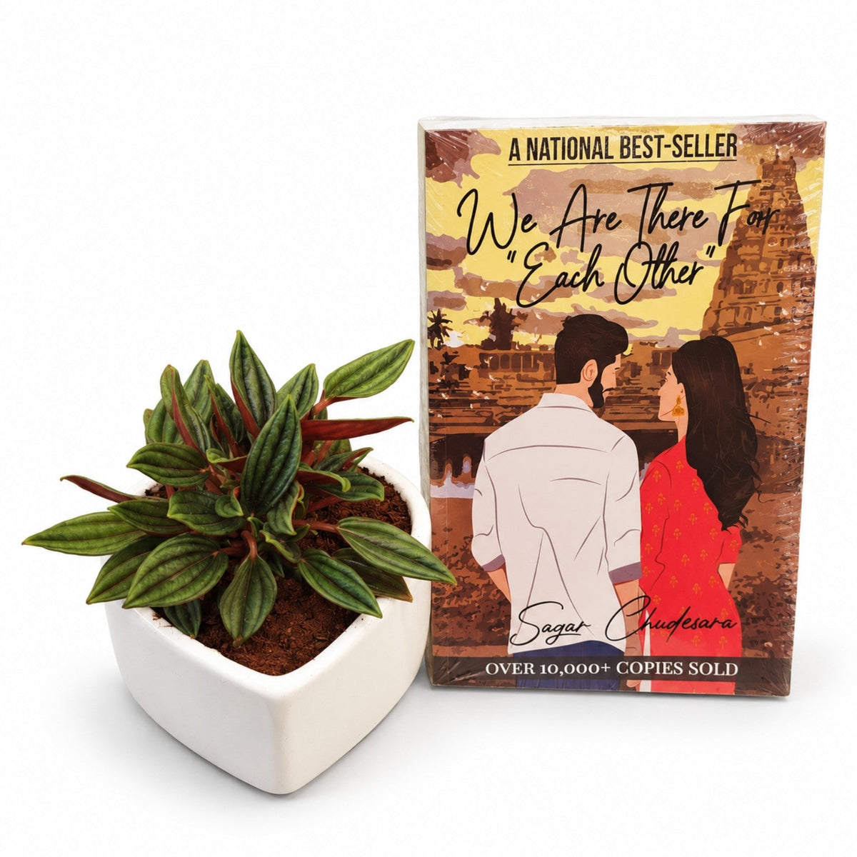 Peperomia Piccolo Banda plant in white heart-shaped planter with We Are There Each Other book